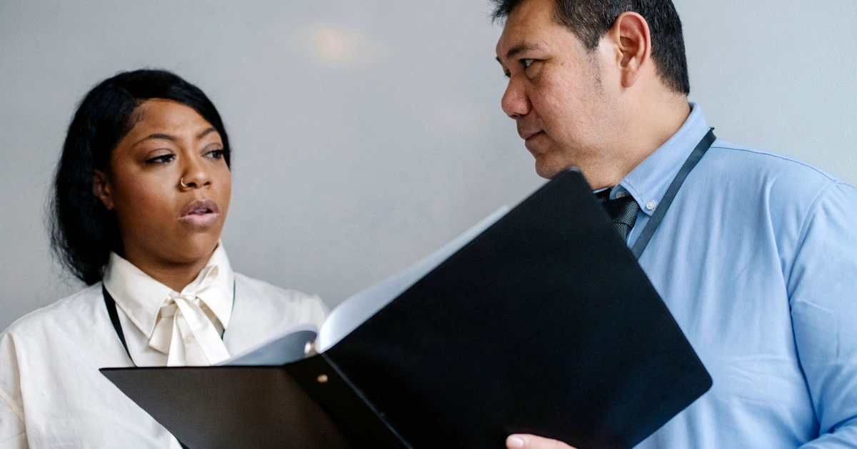 Two professionals reviewing a document together, representing an affiliate link audit and verification process