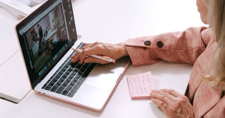 ffiliate marketer planning content at a laptop with a written task list before beginning an article