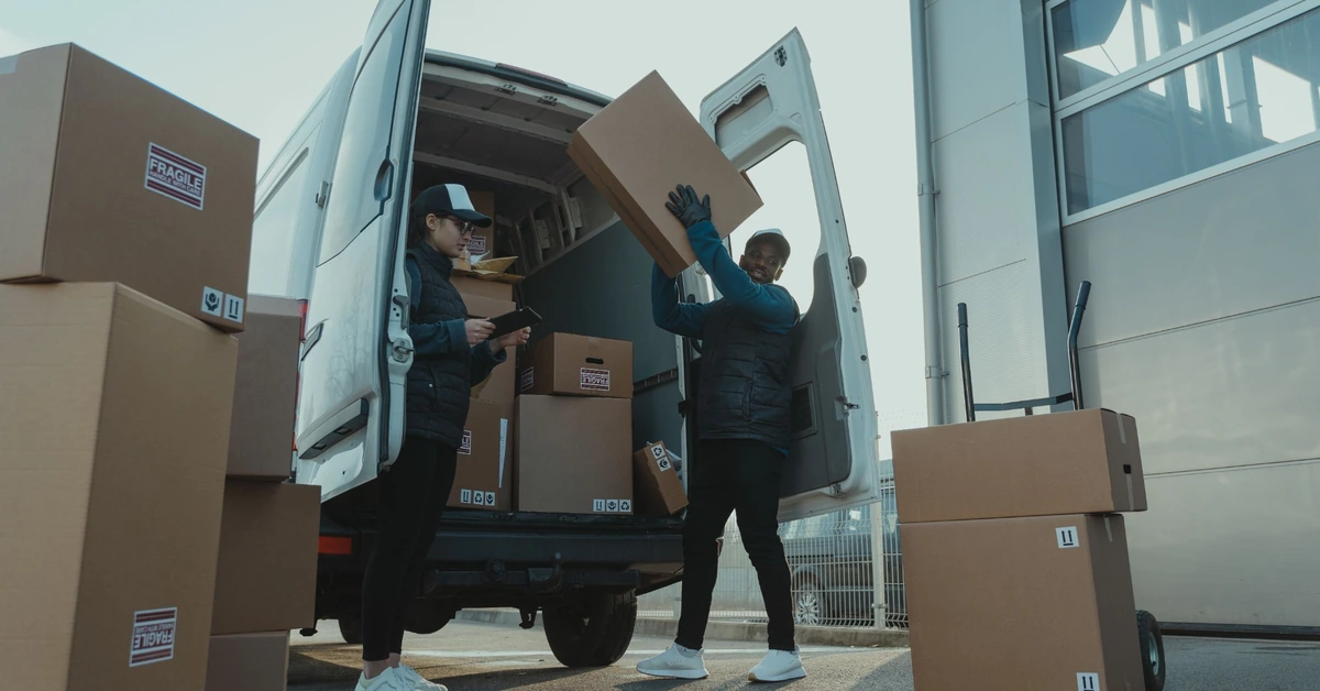 Workers loading packages into a delivery van, illustrating the deliberate distribution of new affiliate blog content to different audiences.