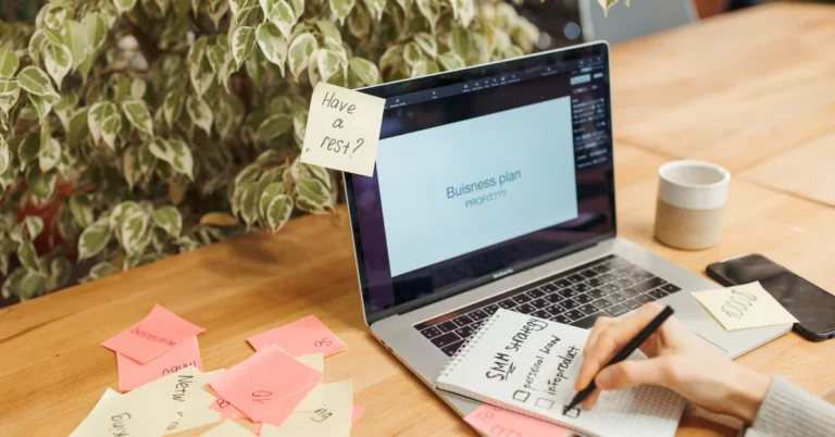 Laptop and scattered sticky notes representing a broad affiliate blog topic being organized into focused ideas.