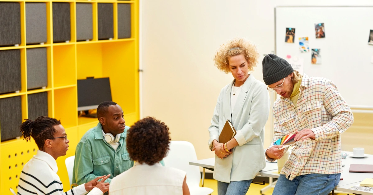 A diverse team collaborating in a bright office while discussing content ideas and planning related topics