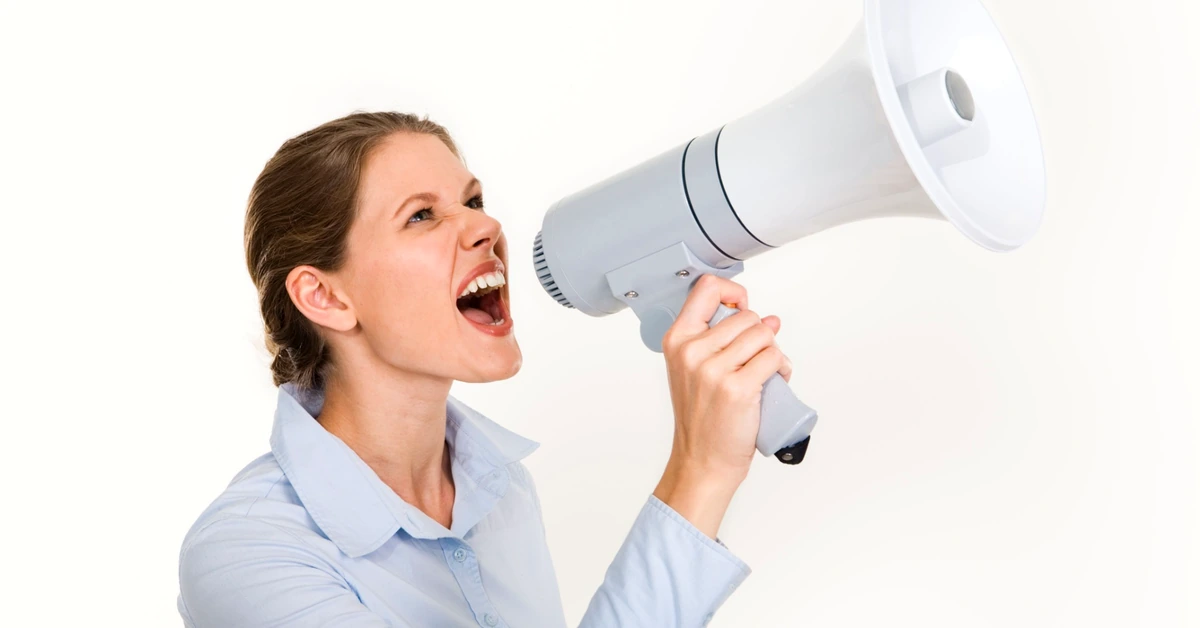 Woman speaking through a megaphone representing clear and conspicuous affiliate disclosure language