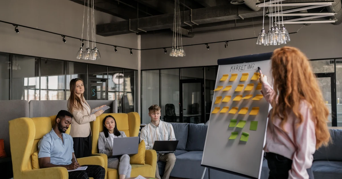 Marketing team planning an email sequence with sticky notes on a presentation board