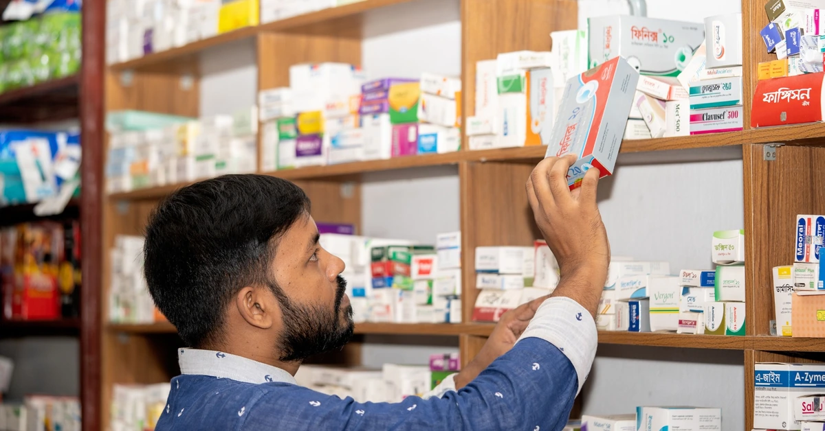 Pharmacist organizing medication on shelves, illustrating how segmentation can help send more relevant affiliate emails to different subscribers.