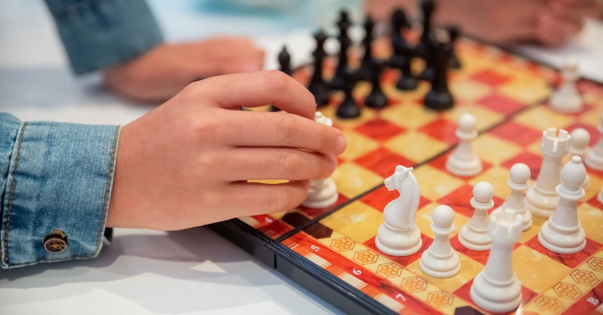 Hands making a deliberate chess move, illustrating how an additional affiliate offer should be chosen strategically based on fit and purpose.