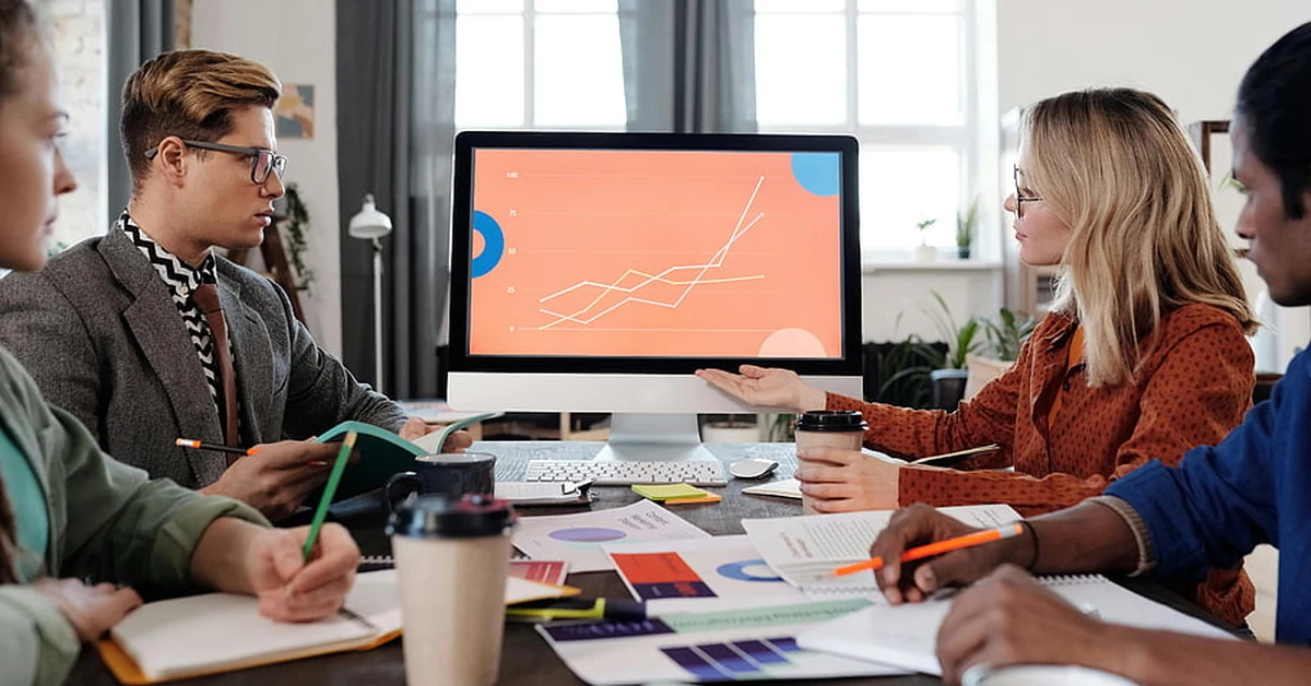 Business team reviewing performance trends on a computer during a meeting