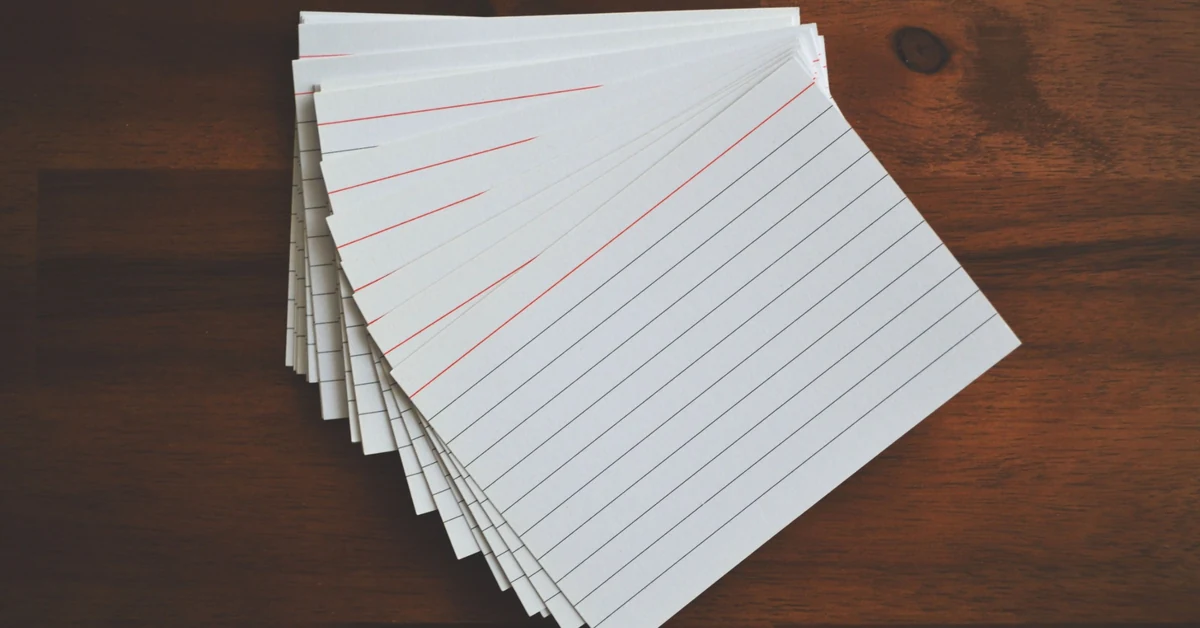 Blank index cards arranged on a wooden desk for organizing content ideas