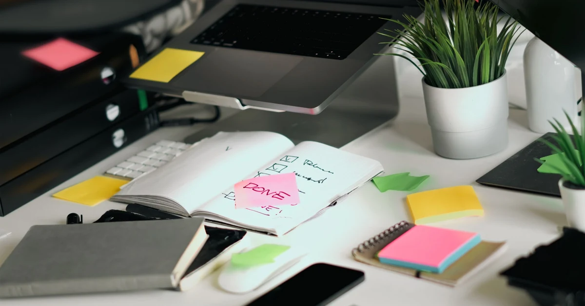 Organized workspace with laptop, notebooks, and checklists used to plan and verify a simple affiliate marketing funnel.