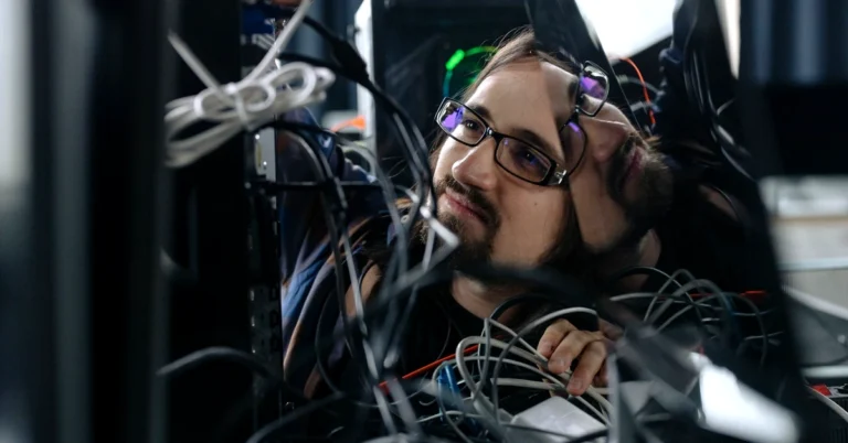 Man working through a tangle of computer cables, representing the need for an organized affiliate link management system