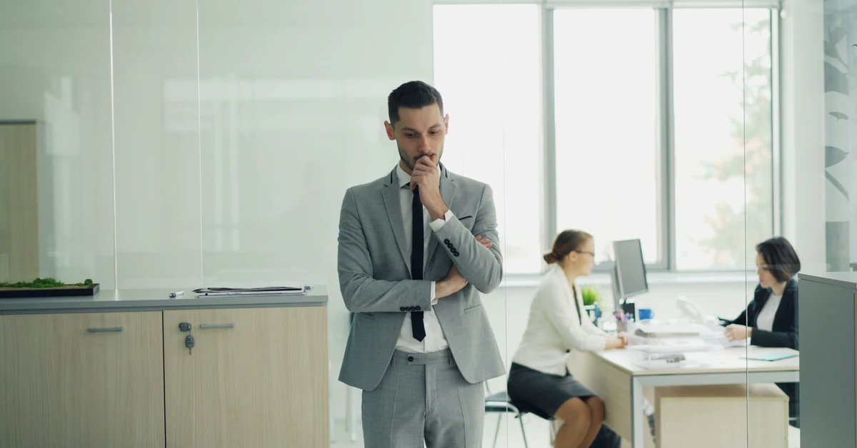 Businessman considering a decision in a modern office