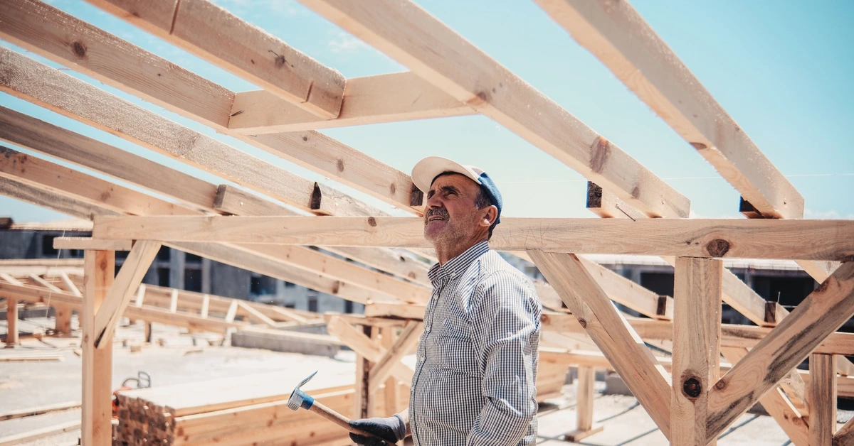 Construction worker inspecting a wooden roof frame, illustrating the decision to keep testing an affiliate offer only when the campaign structure holds up.