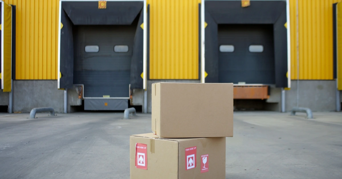 Shipping boxes staged outside warehouse loading docks, illustrating the customer journey that continues after the initial affiliate conversion.