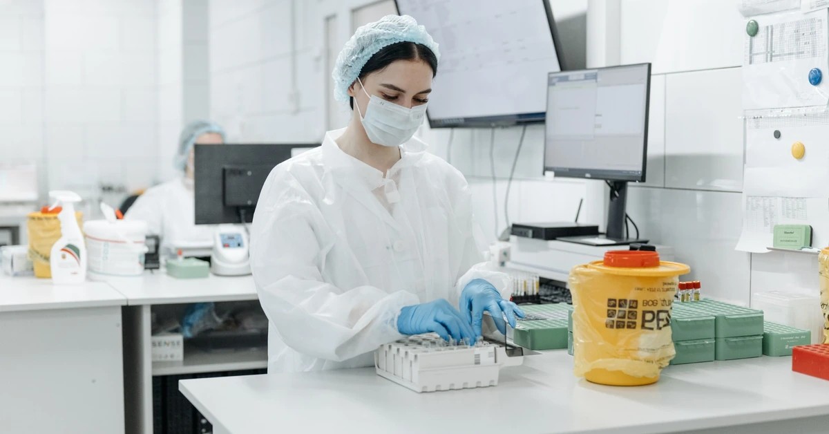 Laboratory professional reviewing test samples, illustrating the need to compare ClickBank offer metrics carefully instead of relying on one number alone.