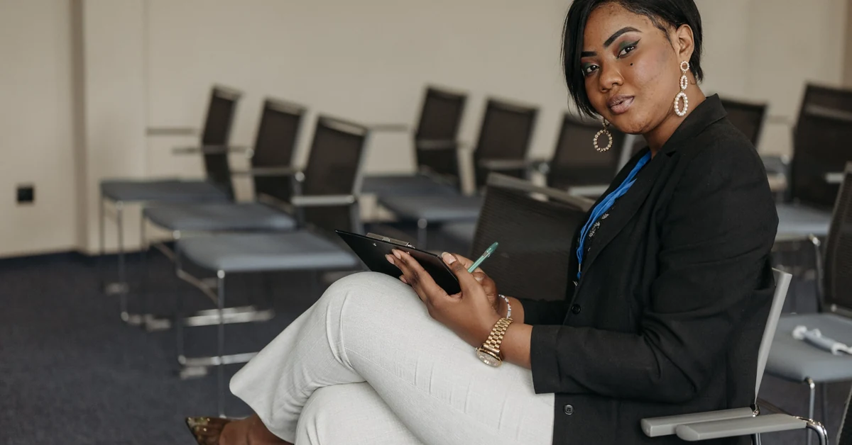 Businesswoman reviewing notes on a clipboard in a conference room