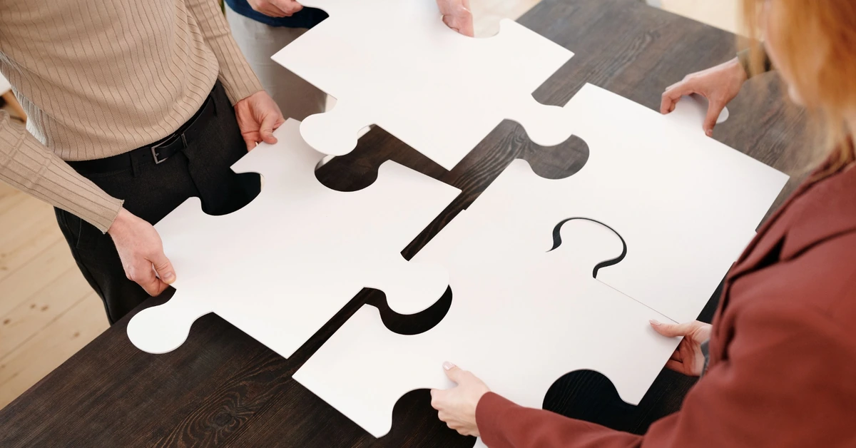 People fitting large puzzle pieces together, representing matching an email opt-in offer to the blog post topic.