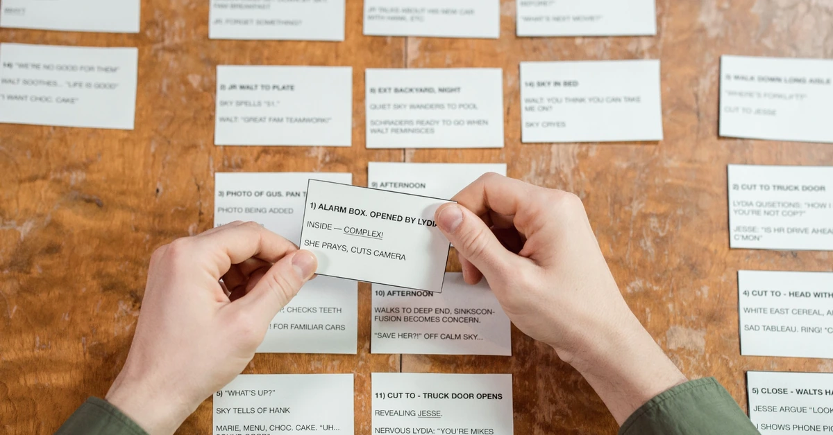 Hands selecting one index card from several options, illustrating the importance of giving a new email subscriber one clear next step.