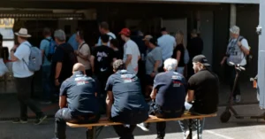 People gathering at an entrance on a sunny day, illustrating the first visitors beginning to discover a new affiliate blog.