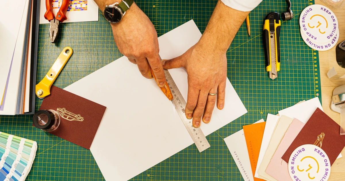 Person using a ruler to measure precisely at a worktable, illustrating the importance of measuring landing-page and email opt-in results.
