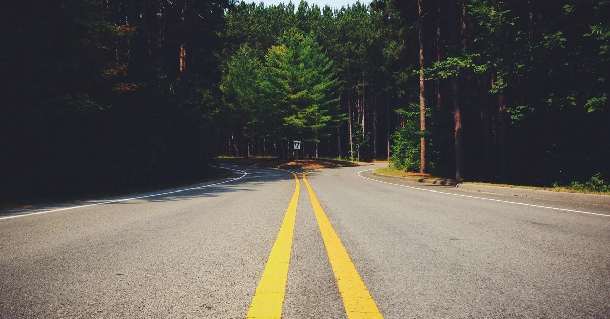 Road splitting into two directions, representing the decision of what to do after a focused 30-day affiliate offer test.