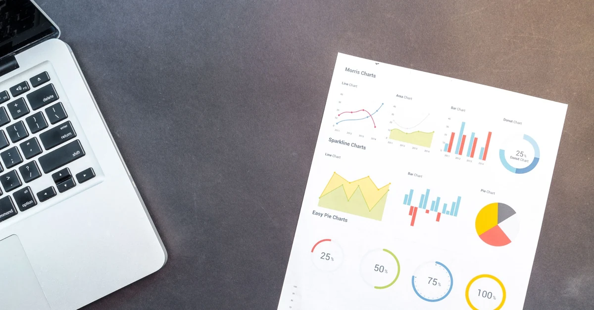 Laptop and printed analytics charts used to compare affiliate marketing traffic, opt-ins, and performance metrics.