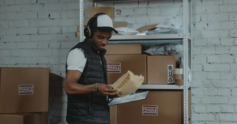 Warehouse worker organizing packages and reviewing a checklist, illustrating how affiliate email subscribers can be grouped into useful segments.