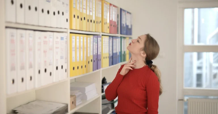 Woman choosing among folders in an office, representing focusing on one offer at a time.