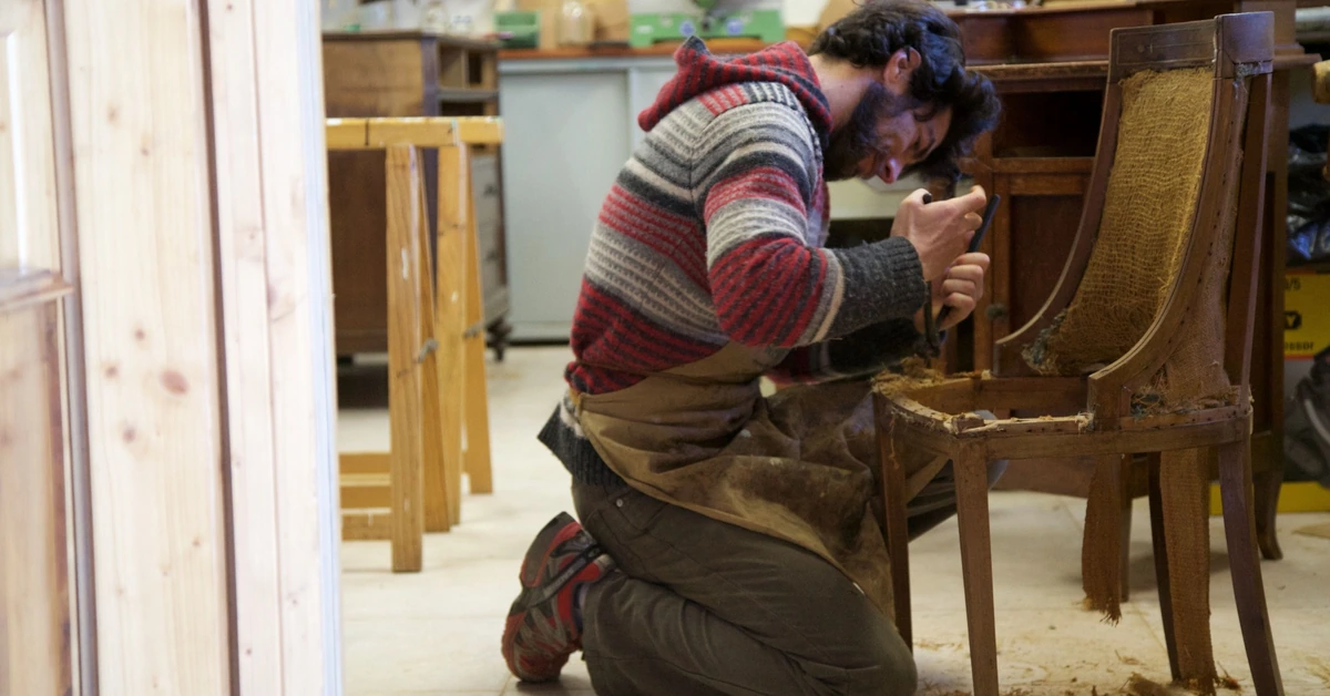 Craftsman restoring an older wooden chair, illustrating how an existing affiliate blog post can be improved instead of replaced.